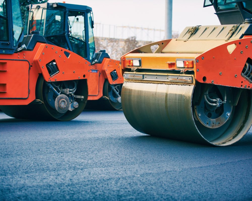 Road roller working on the new road construction site